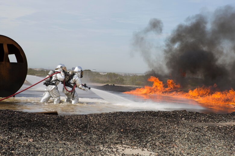 Aircraft Rescue and Firefighting Marines with Headquarters and Headquarters Squadron (HHS) and Marine Wing Support Squadron (MWSS) 473 fight a fuel fire during a controlled burn exercise at the ARFF training pit at Marine Corps Air Station Miramar, Calif., March 4. Marines with ARFF are responsible for any fire or hazardous material mishap that involves an aircraft. (U.S. Marine Corps photo by Lance Cpl. Liah Kitchen/Released)