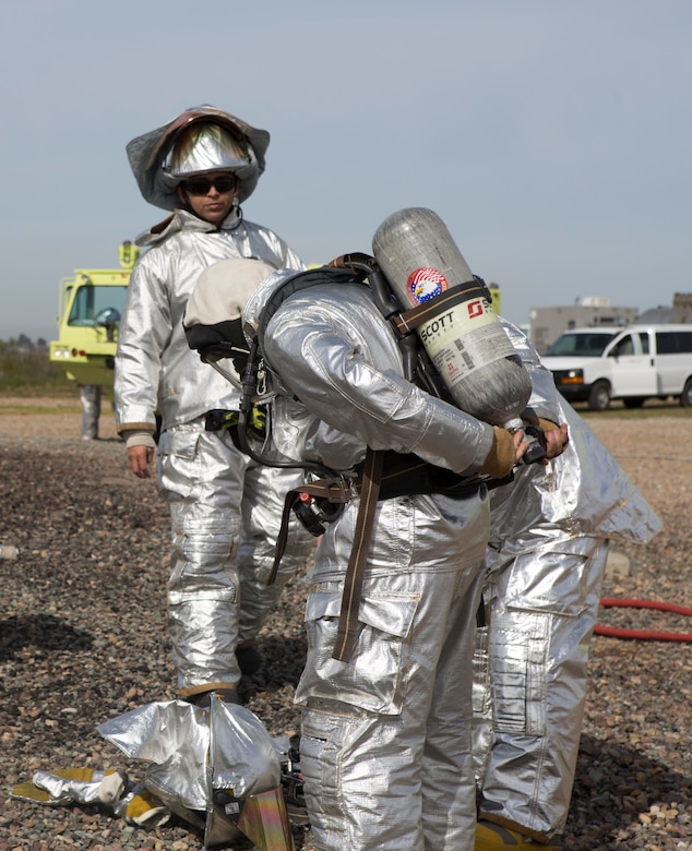 Aircraft Rescue and Firefighting Marines with Headquarters and Headquarters Squadron (HHS) and Marine Wing Support Squadron (MWSS) 473 test their gear before conducting a controlled burn exercise at the ARFF training pit at Marine Corps Air Station Miramar, Calif., March 4. Marines with ARFF are responsible for any fire or hazardous material mishap that involves an aircraft. (U.S. Marine Corps photo by Lance Cpl. Liah Kitchen/Released)