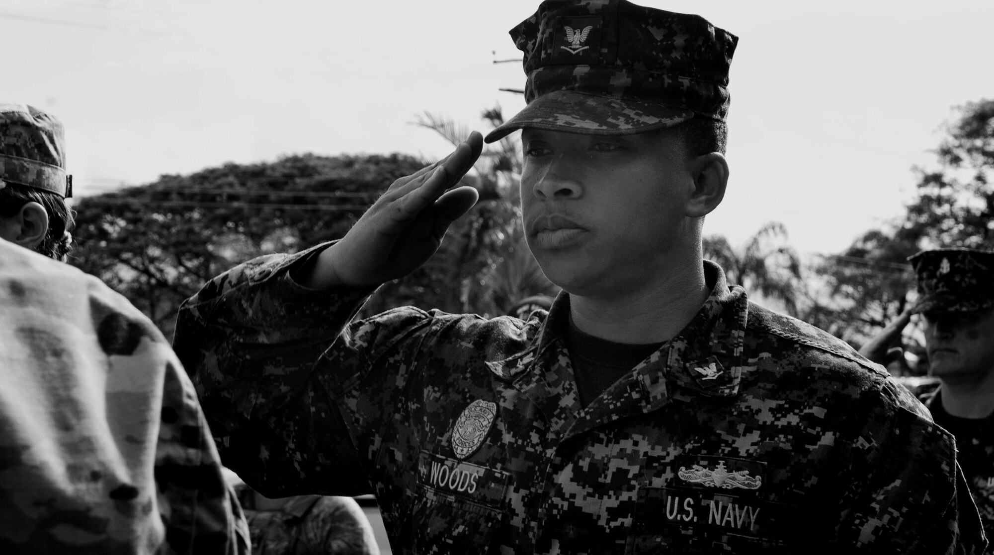 U.S. Navy Petty Officer 3rd Class Cortland Woods, Joint Base Security, JB2 dog handler, salutes military working dog Riki for the last time at the veterinary treatment facility on Joint Base Pearl Harbor-Hickam, Hawaii, March 2, 2017. After six-years of service, Riki was euthanized due to progressive incurable illness. (U.S. Air Force photo by Tech. Sgt. Heather Redman)