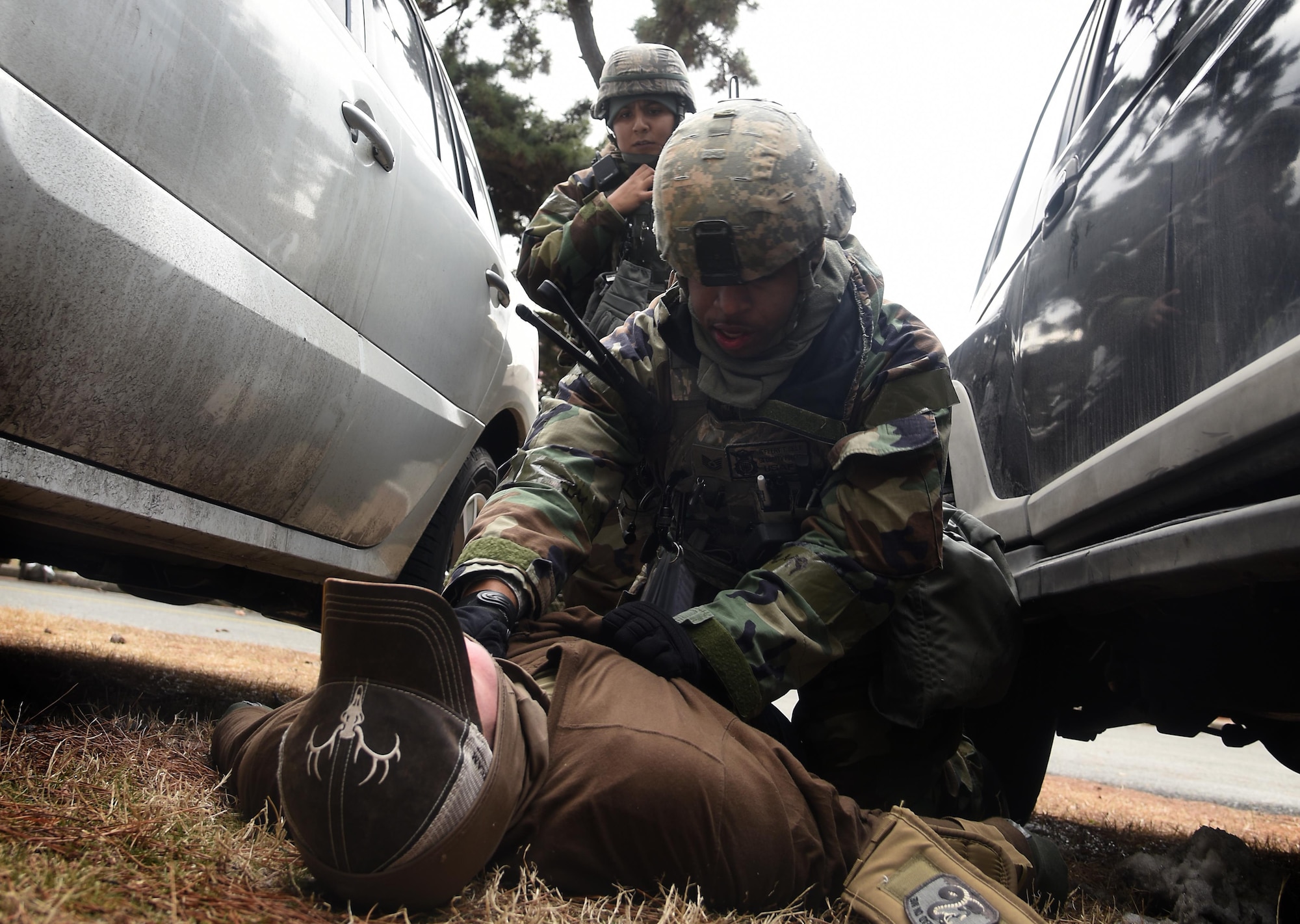 Tech. Sgt. Jeffery Self, middle, and Senior Airman Adela Estrada, back, 8th Security Forces Squadron team members, search an opposing force during a training scenario at Kunsan Air Base, Republic of Korea, March 7, 2017. Self and Estrada performed this procedure as part of exercise Beverly Pack 17-2, a no-notice training exercise used to increase U.S. combat readiness and enhance base defenses. (U.S. Air Force photo by Tech. Sgt. Jeff Andrejcik/Released)