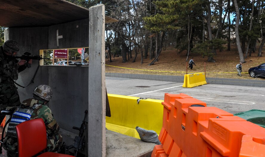 Airman 1st Class Benjamin Hauber, 8th Security Forces Squadron team member, pulls security in a bunker as opposing forces advance, while Airman 1st Class Jeremy Parnell, 8th Security Forces Squadron defender, reloads his weapon while taking cover in a bunker during exercise Beverly Pack 17-2, a no-notice training exercise at Kunsan Air Base, Republic of Korea, March 7, 2017. We train to employ airpower to deter aggression, preserve the Armistice and defend the Republic of Korea. (U.S. Air Force photo by Senior Airman Colville McFee/Released)