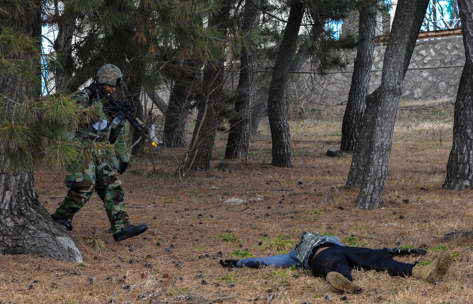 Tech. Sgt. Jeffery Self, 8th Security Forces Squadron team member, advances toward opposing forces during a training scenario at Kunsan Air Base, Republic of Korea, March 7, 2017. Self used the advancing technique as part of exercise Beverly Pack 17-2, a no-notice training exercise used to improve responses to base threats. (U.S. Air Force photo by Senior Airman Colville McFee/Released)