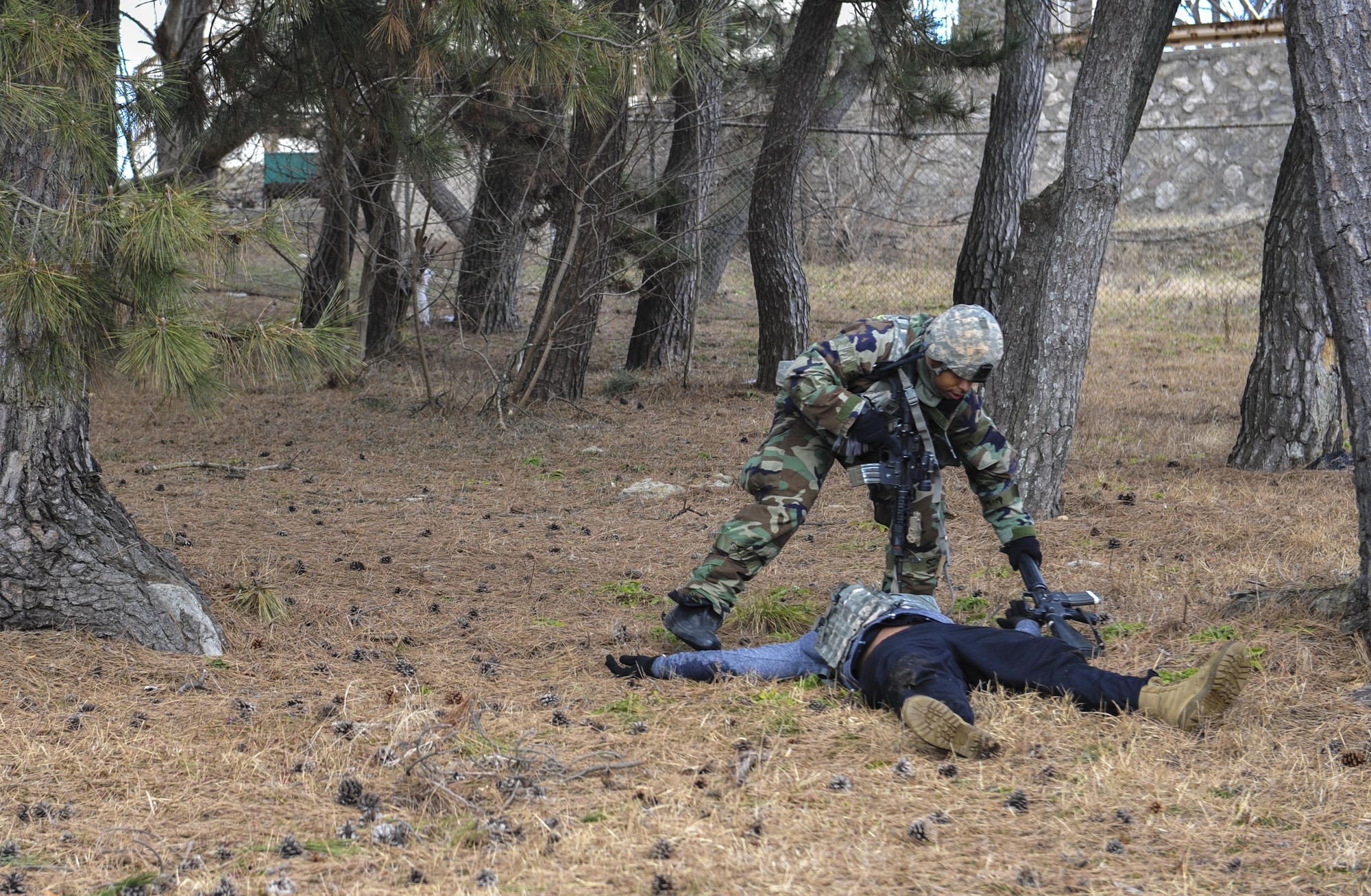 Tech. Sgt. Jeffery Self, 8th Security Forces Squadron team member, removes a weapon from a downed opposing force member during a training scenario at Kunsan Air Base, Republic of Korea, March 7, 2017. Self executed this procedure as part of exercise Beverly Pack 17-2, a no-notice training exercise used to increase U.S. combat readiness and ultimately enhance the U.S. commitment to maintaining peace in the region. (U.S. Air Force photo by Senior Airman Colville McFee/Released)