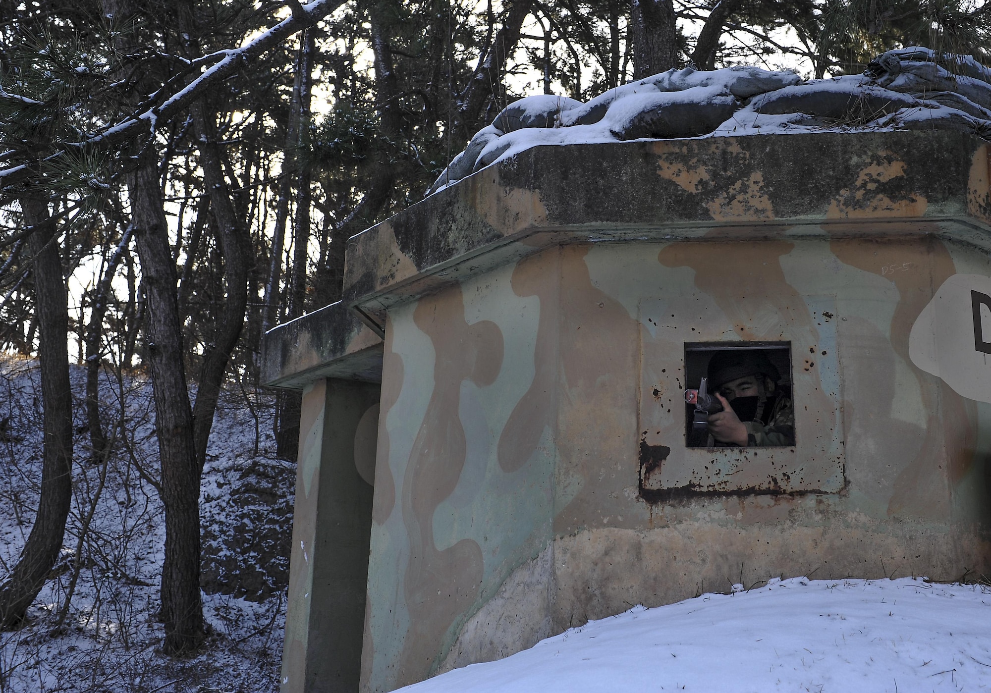Senior Airman John Thorn, 8th Maintenance Squadron aircraft fuels system journeyman, pulls security in a bunker during exercise Beverly Pack 17-2, a no-notice training exercise at Kunsan Air Base, Republic of Korea, March 7, 2017. We train to employ airpower to deter aggression, preserve the Armistice and defend the Republic of Korea. (U.S. Air Force photo by Senior Airman Colville McFee/Released)