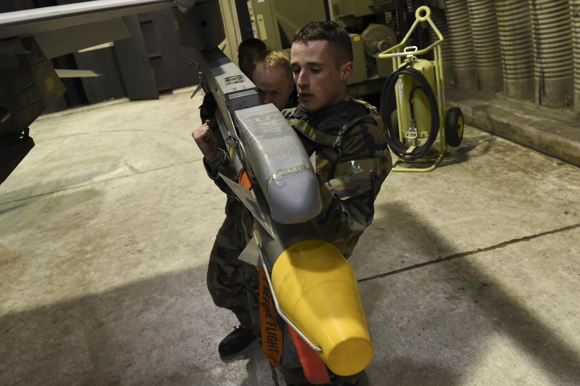 U.S. Air Force Airman 1st Class Reagan Bounner, front, Staff Sgt. Benjamin Callesen, middle, and Airman 1st Class Jillian, 80th Aircraft Maintenance Unit weapons load crew members, mount an Aim-9X Sidewinder air-to-air missile onto an F-16 Fighting Falcon during exercise Beverly Pack 17-2, a no-notice training exercise at Kunsan Air Base, Republic of Korea, March 7, 2017. These employment exercises are used to increase U.S. combat readiness and ultimately enhance the U.S. commitment to maintaining peace in the region. (U.S. Air Force photo by Senior Airman Michael Hunsaker/Released)