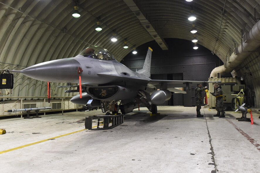 U.S. Air Force Airman 1st Class Reagan Bounner and Staff Sgt. Benjamin Callesen, 80th Aircraft Maintenance Unit weapons load crew members, fasten an Aim-9X Sidewinder air-to-air missile onto an F-16 Fighting Falcon during exercise Beverly Pack 17-2, a no-notice training exercise at Kunsan Air Base, Republic of Korea, March 7, 2017. This exercise was conducted to enhance combat capabilities and improve response times if in contingency operations. (U.S. Air Force photo by Senior Airman Michael Hunsaker/Released)