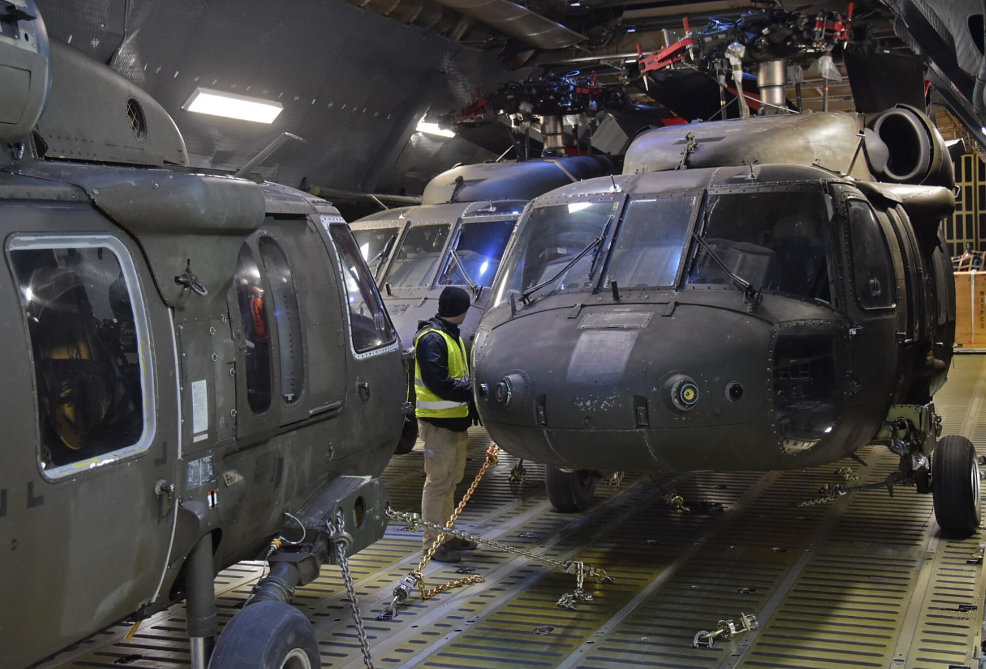 Three U.S. Army UH-60 Blackhawk helicopters belonging to the 10th Combat Aviation Brigade from Ft. Drum, N.Y. are secured and readied for transport on an Air Mobility Command C-5M Super Galaxy on Feb., 27, 2017.  The helicopters and 22 Army Soldiers were flown by Air Force Reserve Command's 68th Airlift Squadron to Riga, Latvia as part of Operation Atlantic Resolve. (U.S. Air Force photo/Tech. Sgt. Carlos J. Trevino)