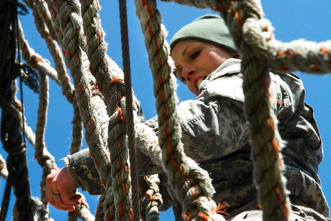 Army Sgt. Amanda Spear descends a rope ladder on the obstacle course for the Indiana National Guard Best Warrior Competition at Camp Atterbury, Ind., March 4, 2017. Spear is assigned to the 638th Aviation Support Battalion. During the event, soldiers needed to demonstrate proficiency in warrior tasks and skills, including marksmanship, emergency first aid and land navigation. Army National Guard photo by Sgt. Evan Myers