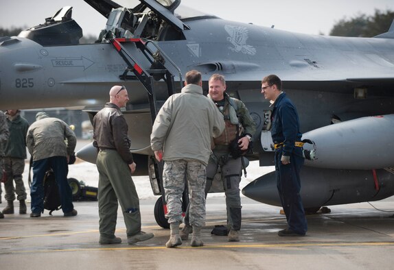 U.S. Air Force Chief Master Sgt. Charles Frizzell, 35th Fighter Wing command chief, shakes Lt. Col. Mark Heusinkveld, 14th Fighter Squadron commander's, hand at Misawa Air Base, Japan, March 4, 2017. Heusinkveld returned from exercise COPE NORTH 17, which originated here in 1978 and serves as a keystone event promoting stability and security throughout the Indo-Asia-Pacific region by enabling regional forces to hone vital readiness skills critical to maintaining regional stability. (U.S. Air Force photo by Senior Airman Brittany A. Chase)