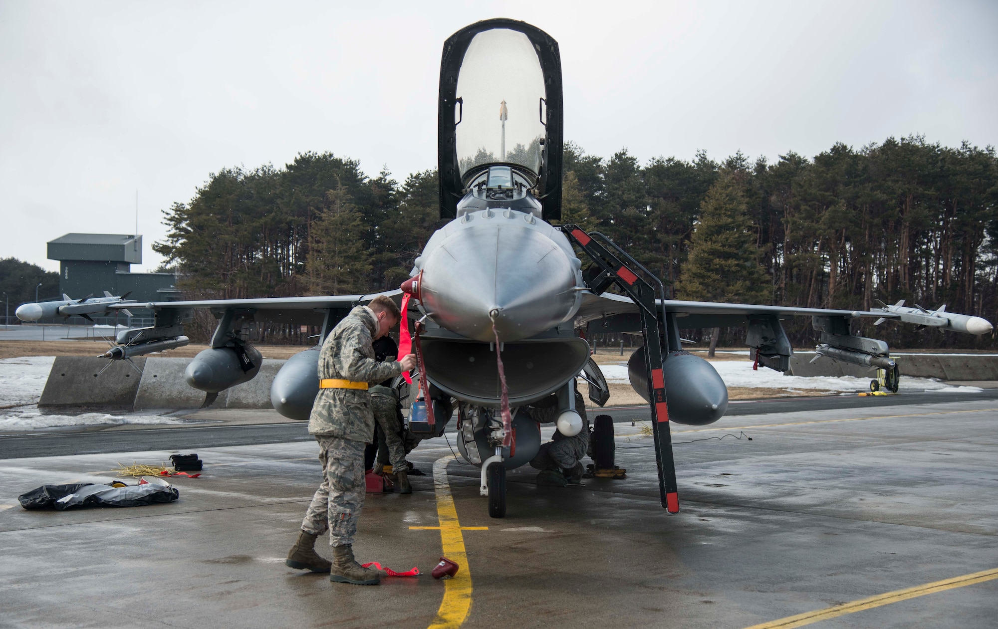 Airman 1st Class Shelby Flowers, 14th Aircraft Maintenance Unit avionics technician, places a cover on an F-16 Fighting Falcon at Misawa Air Base, Japan, March 4, 2017. Aircraft returned from COPE NORTH 17, an annual exercise serving as a keystone event promoting stability and security throughout the Indo-Asia-Pacific region. COPE NORTH dates back to 1978 when it took place here. (U.S. Air Force photo by Senior Airman Brittany A. Chase)