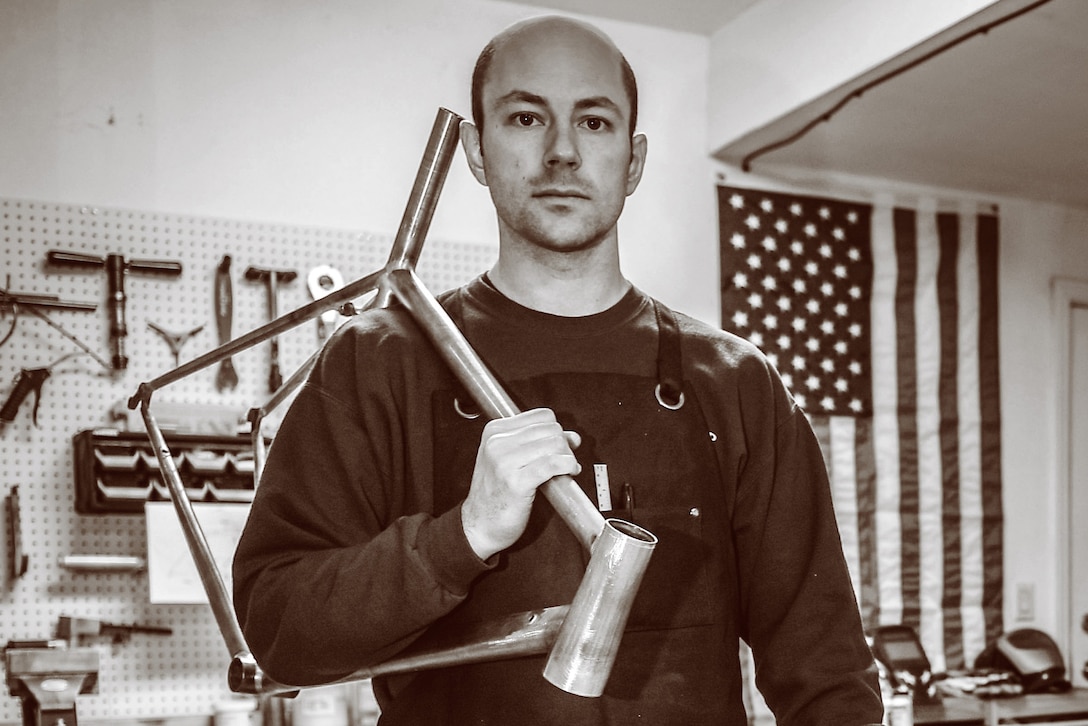 Air Force 1st Lt. Ken Cerreta, a program manager in the F-16 System Program Office at Hill Air Force Base, Utah, poses with a nearly complete bicycle frame he built over about 80 hours in his garage, Jan. 28, 2017. Air Force photo by Paul Holcomb