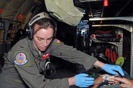 1st Lt. Carol Roling, flight nurse with the 375th Aeromedical Evacuation Squadron from Scott Air Force Base, Ill., checks on a patient during an aeromedical evacuation flight from the Pacific theater to the U.S. on Feb. 21, 2017. A Utah Air Guard KC-135R Stratotanker and six-person crew from the 151st Air Refueling Squadron conducted an AE mission with the active duty medical personnel Feb. 18-25, 2017. 