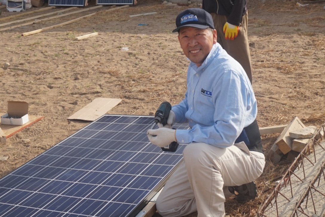 Peter Cho, an electrical engineer in the marine and aviation division at the Naval Surface Warfare Center, Carderock Division, in West Bethesda, Md., prepares a solar panel to bring light to a community in the rural West African city of Mbour, Senegal. Courtesy photo