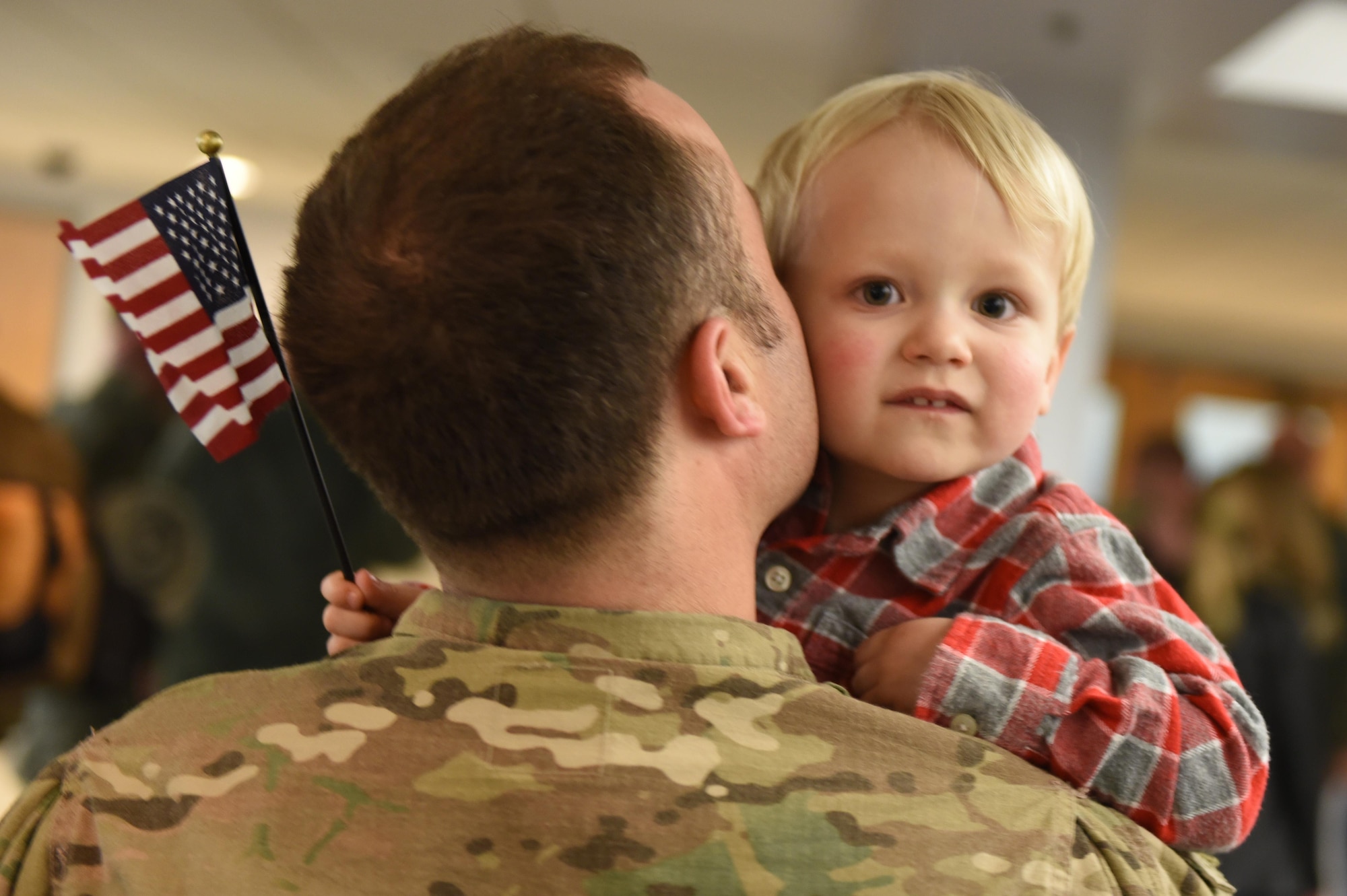 A 621st Contingency Response Wing Airman hugs and kisses his son after returning from a four-month deployment in support of Operation Inherent Resolve, March 6, 2017, at Joint Base McGuire-Dix-Lakehurst, N.J. (U.S. Air Force photo by Airman 1st Class Zachary Martyn/RELEASED)