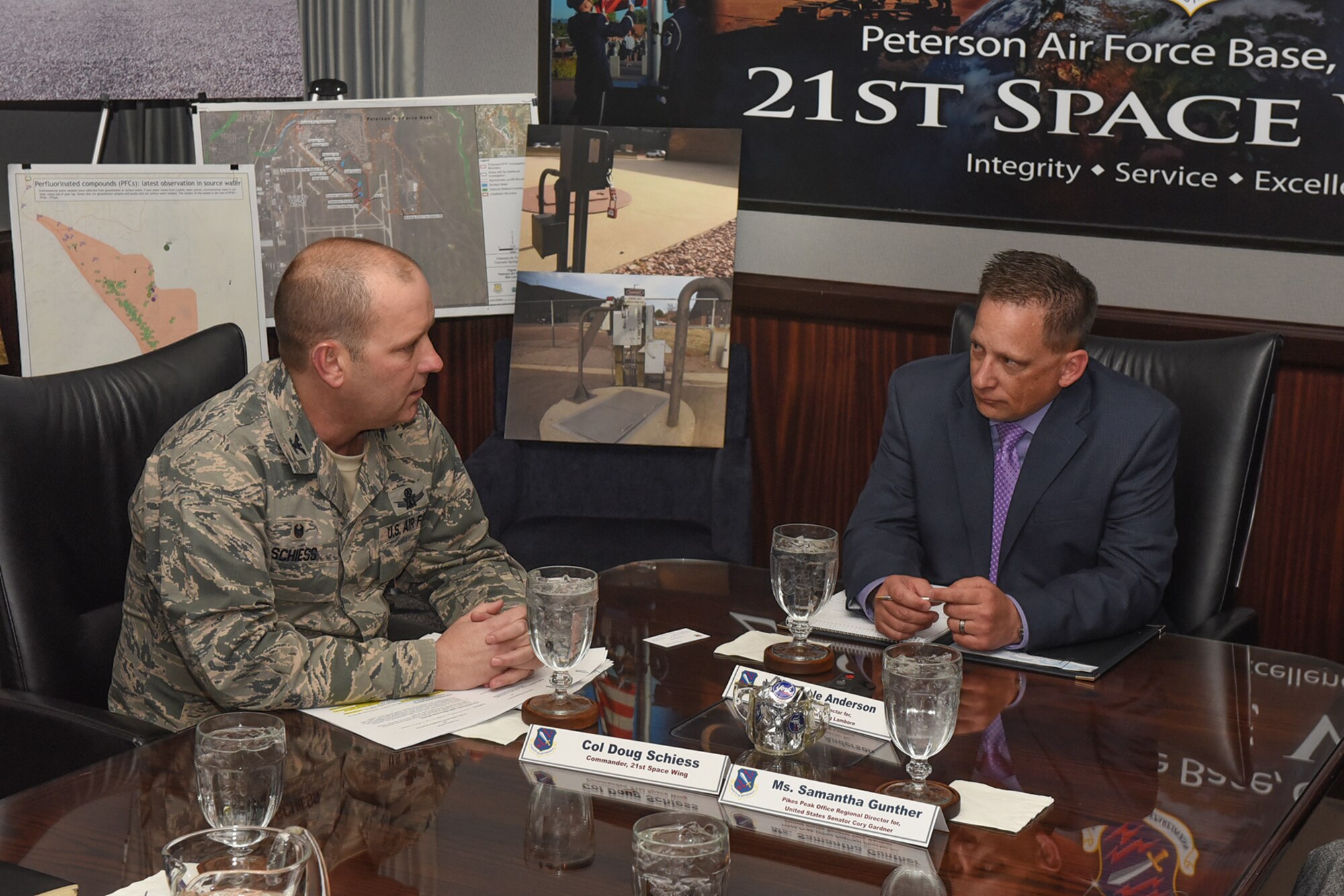 Col. Doug Schiess, 21st Space Wing commander, briefs U.S. House Representative Doug Lamborn’s district director, Dale Anderson, on the wing’s investigation of potential water contamination here Feb. 28, 2017.

Schiess updated Anderson and U.S. Senator Cory Gardner’s Pike Peak Office Regional Director Samantha Gunther on the Air Force’s plans to mitigate potential PFOA/PFOS contamination to the public.  The Air Force funded $4.1 million to assist the community by installing water purification units to local resident’s wells; working with Fountain, Security and Widefield water purveyors for filtration solutions; and providing bottled water to many affected citizens. Also discussed was the Air Force’s progress in the Comprehensive Environmental Response, Compensation, and Liability Act investigation process to determine where the contamination may be coming from.

Local congressional staff are briefed on a regular basis on a variety of installation issues so they can keep their Washington, D.C. leadership informed. (U.S. Air Force photo by Philip Carter)
