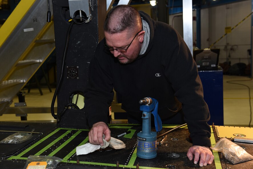 Bob Berg, M1 Support Services aircraft mechanic, installs new floor paneling on a UH-1N Huey helicopter during a scheduled phase maintenance inspection on the aircraft March 6, 2017, at Malmstrom Air Force Base, Mont.  The phase inspection period usually lasts 4 to 6 weeks and routinely occurs after 400 flight hours.  Berg, along with three other mechanics maintain, upgrade and inspect aircraft to ensure the aircrafts are flight ready.  (U.S. Air Force photo/Jason Heavner)