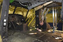 Bob Berg, M1 Support Services aircraft mechanic measures rivets to ensure a proper fitting as floor panels are installed on a AH-1N Huey helicopter during a scheduled phase maintenance inspection on the aircraft March 6, 2017, at Malmstrom Air Force Base, Mont.  The phase inspection period usually lasts 4 to 6 weeks and routinely occurs after 400 flight hours.  (U.S. Air Force photo/Jason Heavner)