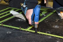A rivet gun is used to fasten rivets as new floor paneling is installed on a UH-1N Huey helicopter during a scheduled phase maintenance inspection on the aircraft March 6, 2017, at Malmstrom Air Force Base, Mont.  The phase inspection period usually lasts 4 to 6 weeks and routinely occurs after 400 flight hours.  (U.S. Air Force photo/Jason Heavner)