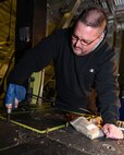 Bob Berg, M1 Support Services aircraft mechanic, uses a rivet gun to secure rivets in place as he installs new floor paneling on a UH-1N Huey helicopter during a scheduled phase maintenance inspection on the aircraft March 6, 2017, at Malmstrom Air Force Base, Mont.  The phase inspection period usually lasts 4 to 6 weeks and routinely occurs after 400 flight hours.  Berg, along with three other mechanics maintain, upgrade and inspect aircraft to ensure the aircrafts are flight ready.  (U.S. Air Force photo/Jason Heavner)