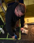 Bob Berg, M1 Support Services aircraft mechanic, uses a rivet gun to secure rivets in place to secure new floor paneling on a UH-1N Huey helicopter during a scheduled phase maintenance inspection on the aircraft March 6, 2017, at Malmstrom Air Force Base, Mont.  The phase inspection period usually lasts 4 to 6 weeks and routinely occurs after 400 flight hours.  Berg, along with a team of three other mechanics, ensure components such as wiring, hydraulic lines and other vital components are operating at Air Force standards.  (U.S. Air Force photo/Jason Heavner)