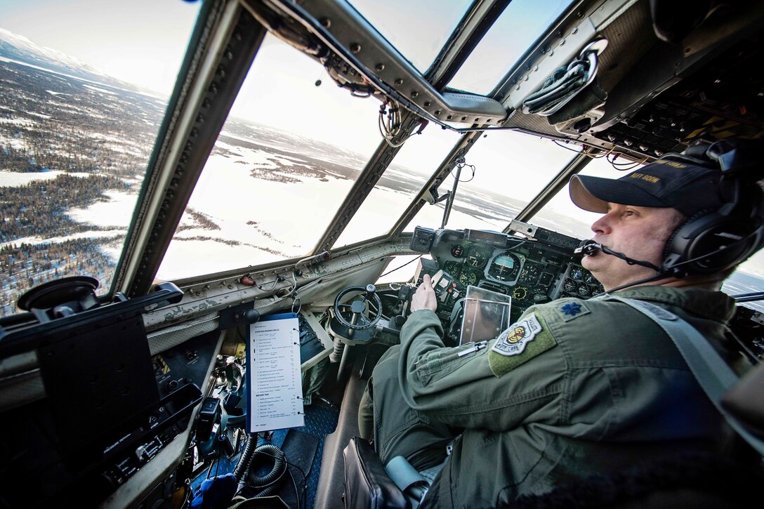 Air Force Lt. Col. Marty Armentrout with the Alaska Air National Guard's 144th Airlift Squadron flies a C-130 Hercules aircraft over Joint Base Elmendorf-Richardson, Alaska, March 4, 2017.  Air National Guard photo by Staff Sgt. Edward Eagerton