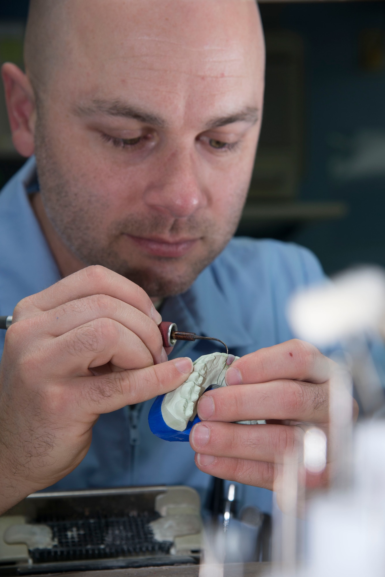 Master Sgt. John Maynard, 436th Aerospace Medicine Squadron dental flight NCO in charge of the laboratory element, builds a wax tooth March 7, 2017, at Dover Air Force Base, Del. The wax tooth is used to create a negative mold, which is later filled with different materials to become the final product. (U.S. Air Force photo by Staff Sgt. Jared Duhon)