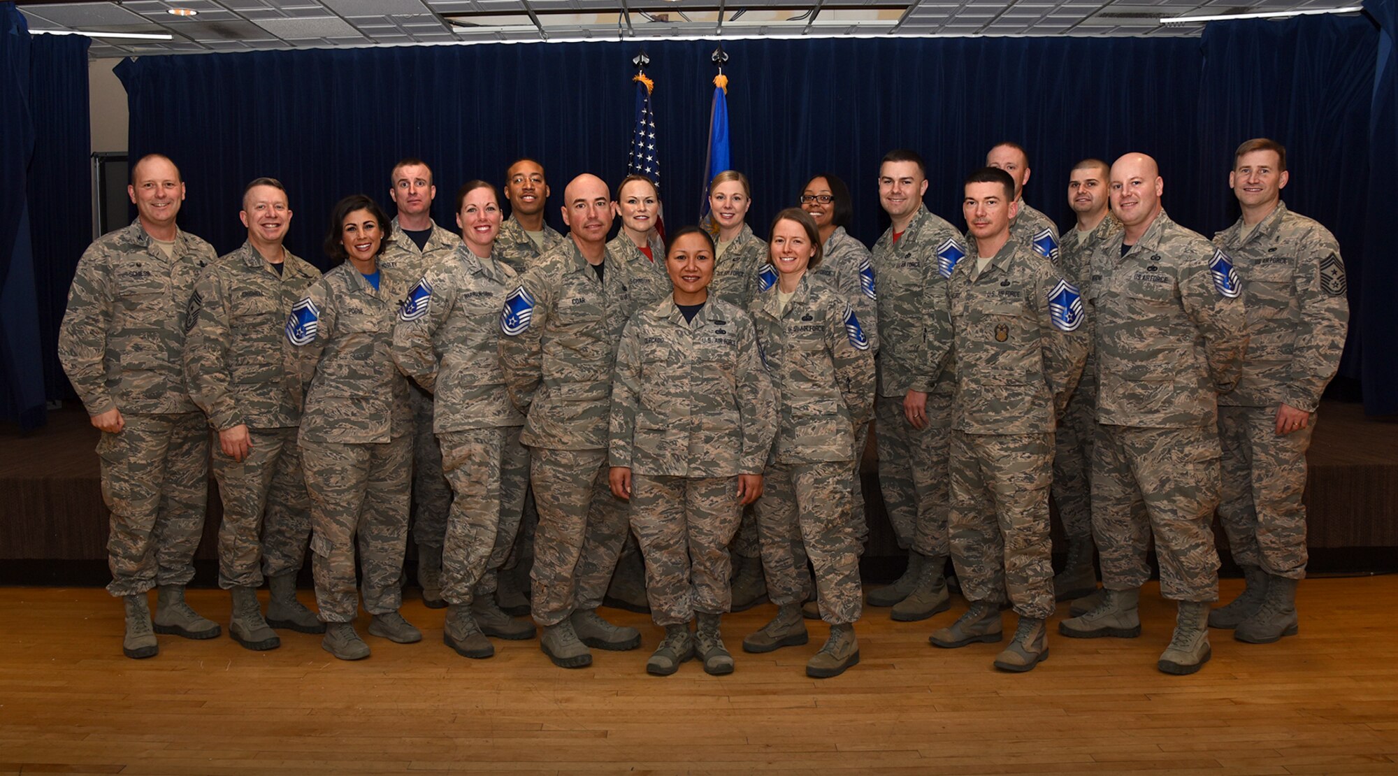 PETERSON AIR FORCE BASE, Colo. – Col. Doug Schiess, 21st Space Wing commander, Chief Master Sgt. Brendan Criswell, Air Force Space Command command chief, and Chief Master Sgt. Mark Bronson, 21st SW command chief, stand alongside Team Pete’s newest senior master sergeant selects during a promotion release party at Peterson Air Force Base, Colo., March 3, 2017. (U.S. Air Force photo by Airman 1st Class Dennis Hoffman)