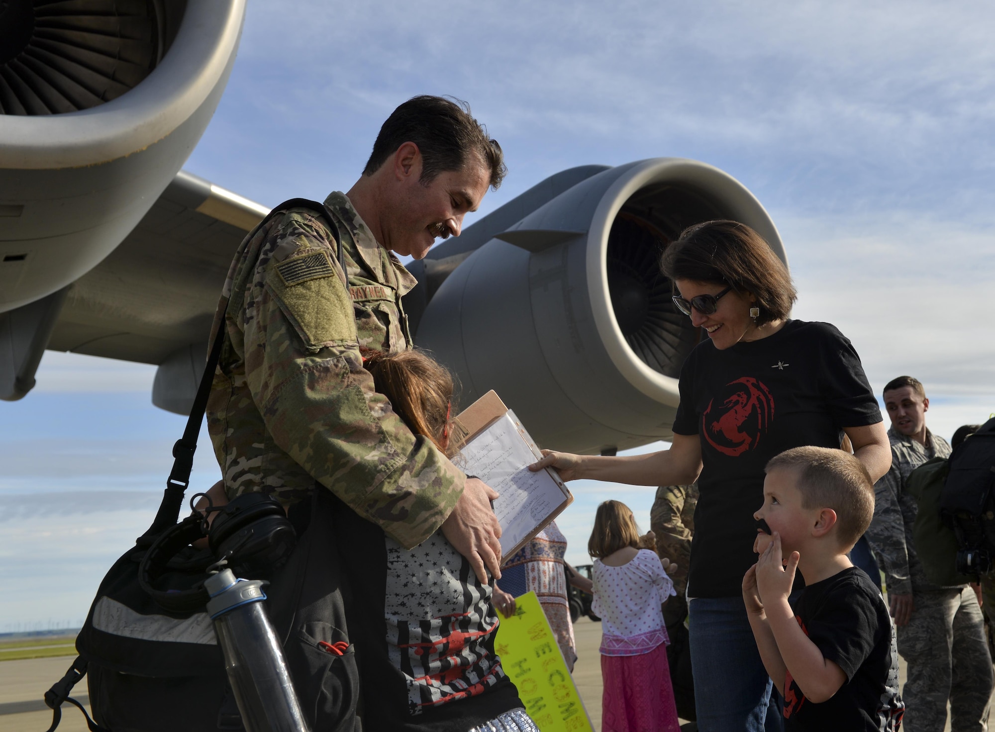 An Airman with the 621st Contingency Response Wing is welcomed home by his family at Travis Air Force Base, Calif., upon completing a four-month deployment in support of Operation Inherent Resolve, March 7, 2017. The 621st CRW—America’s only CRW—is a unique, bi-coastal unit whose forces are primarily stationed at both Travis AFB and Joint Base McGuire-Dix-Lakehurst, N.J. The 621st CRW consists of approximately 1,500 Airmen assigned to three groups, 11 squadrons and more than 20 geographically-separated operating locations aligned with major Army and Marine Corps combat units. (U.S. Air Force photo by Master Sgt. Joseph Swafford)