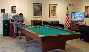 U. S. Air Force Senior Airman Anthony Tucker, Airman Leadership School student, plays pool at the USO’s multipurpose activity room at Joint Base Langley-Eustis, Va., Feb. 28, 2017. The Langley Air Force Base USO center, located in the Professional Development Center, provides a lounge area for ALS students and offers free snacks, coffee, books, cable television, video games, computer access, Wi-Fi and printers for service members and their families. (U. S. Air Force photo by Beverly Joyner)