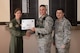 Airman 1st Class Matthew McGonigal, 47th Security Forces Squadron patrolman (center), accepts the “XLer of the Week” award from Col. Michelle Pryor, 47th Flying Training Wing vice commander (left), and Chief Master Sgt. George Richey, 47th FTW command chief (right), on Laughlin Air Force Base, Texas, March 2, 2017. The XLer is a weekly award chosen by wing leadership and is presented to those who consistently make outstanding contributions to their unit and Laughlin. (U.S. Air Force photo/Airman 1st Class Daniel Hambor)