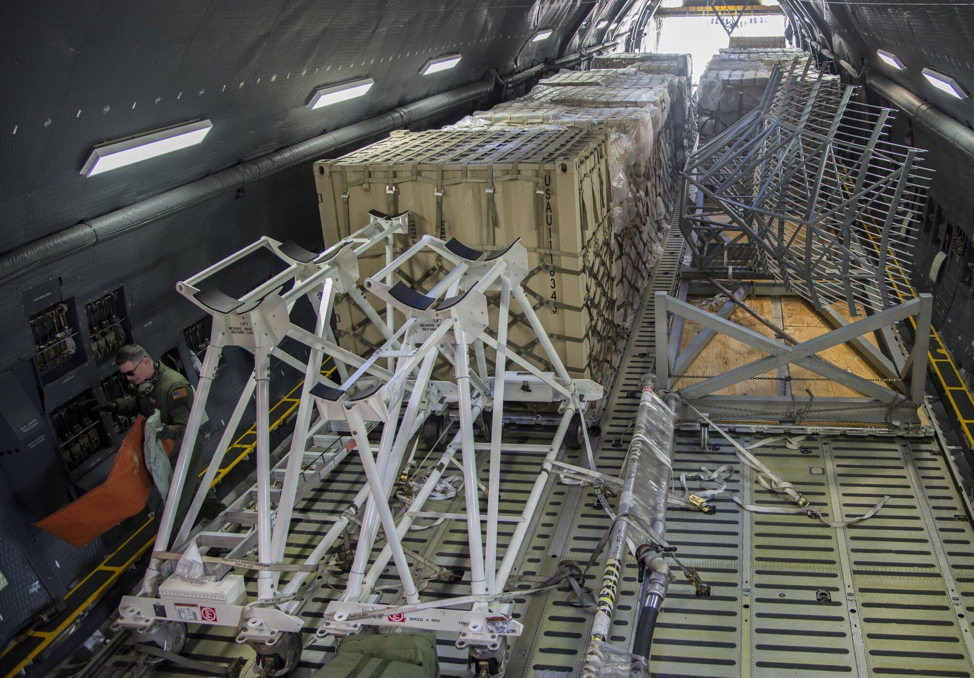 Staff Sgt. Matthew Larson, 22nd Aiirlift Squadron, secures cargo on a C-5M Super Galaxy prior to a flight to Yokota Air Base Japan, March 4, 2017. Larson and his team of loadmasters secured approximately 70,000 pounds of cargo along with seven passengers flying Space-Avaliable travel. (U.S. Air Force photo/Staff Sgt. Nicole Leidholm)