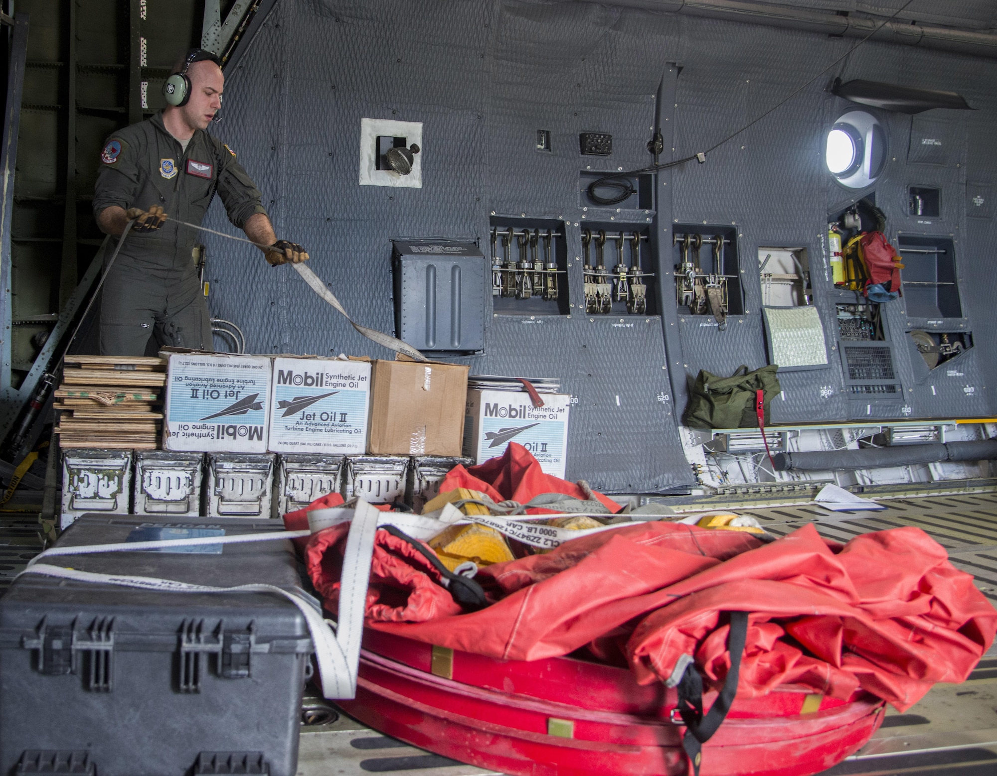 Senior Airman Elias Wilson, 22nd Airlift Squadron, secures cargo on a C-5M Super Galaxy prior to a flight to Yokota Air Base Japan, March 4, 2017. Wilson, along with two other loadmasters, secured approximately 70,000 pounds of cargo along with seven passengers flying Space-Avaliable travel. (U.S. Air Force photo/Staff Sgt. Nicole Leidholm)
