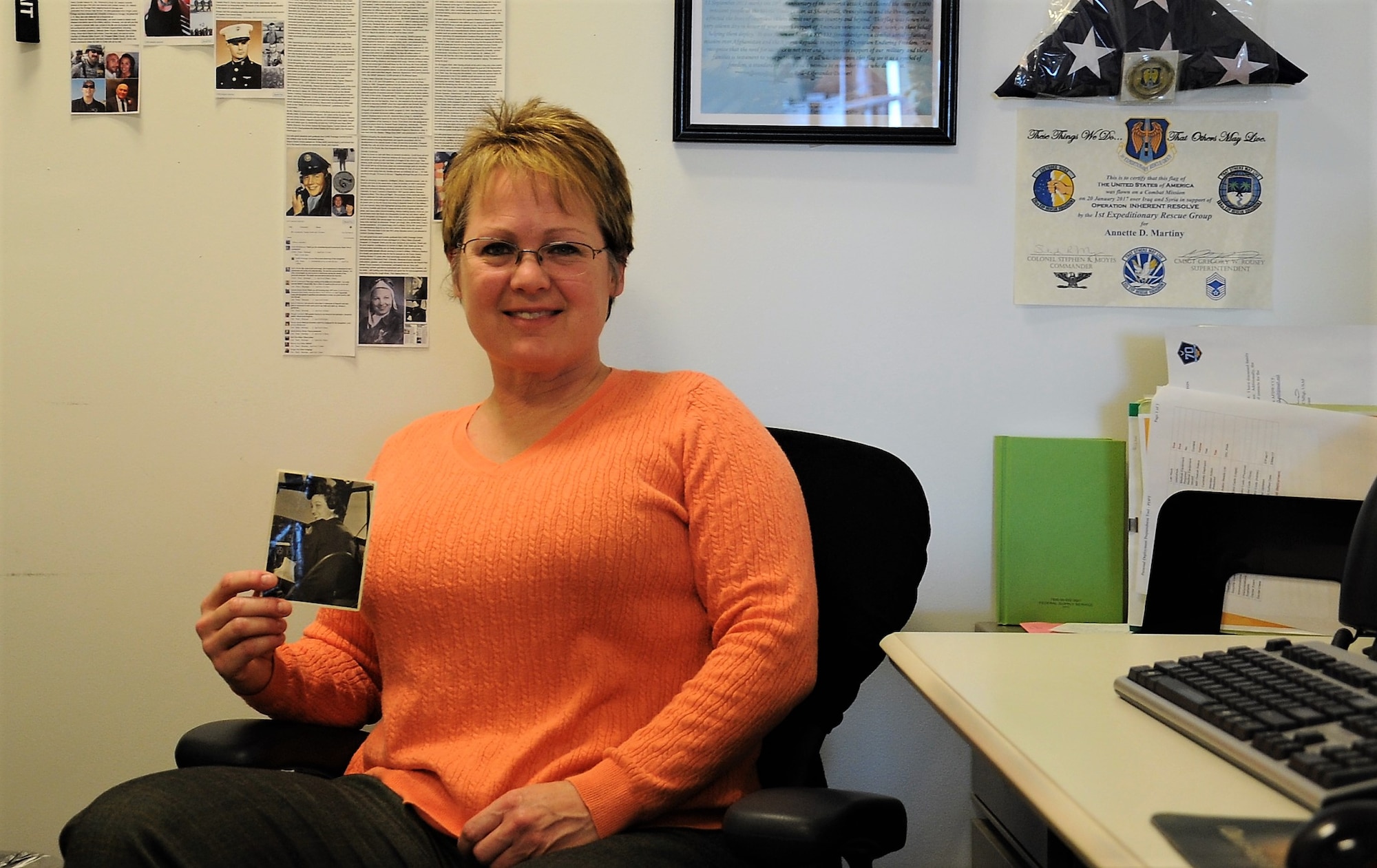 Annette Martiny, Air Force District of Washington unit deployment manager, displays a photo of Women's Airforce Service pilot, Lt. Mary Helen Gosnell, in her office March 8, 2017 at Joint Base Andrews, Md. Martiny befriended Gosnell in 1987 while she was completing Air Force technical training at Lowry Air Force Base, located near Gosnell's residence in Woodland Park, Colo. (U.S. Air Force photo by Staff Sgt. Joe Yanik)