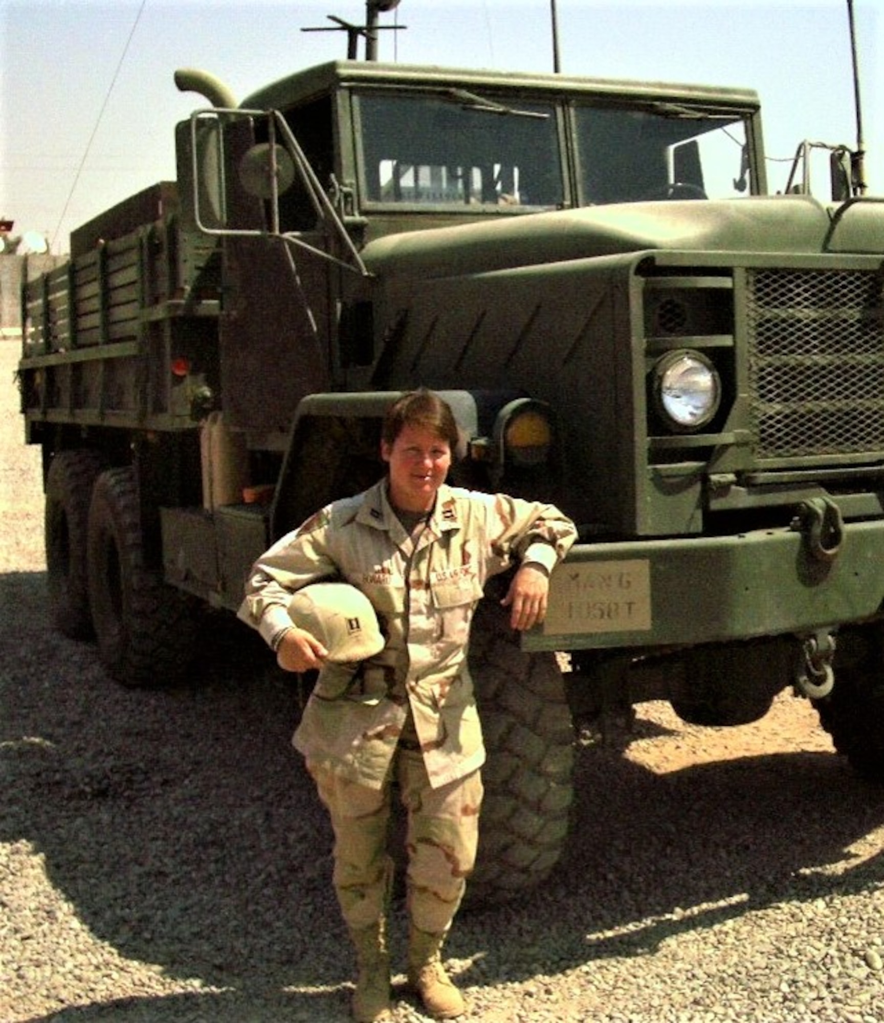 Former Air Force Capt. Annette Martiny poses alongside an M923 5-ton series cargo truck at an undisclosed location in Iraq, Sept. 3, 2004. Commissioned as an officer in 1999, Martiny deployed three times as a logistics plans officer in her 22-year Air Force career. (Courtesy photo)