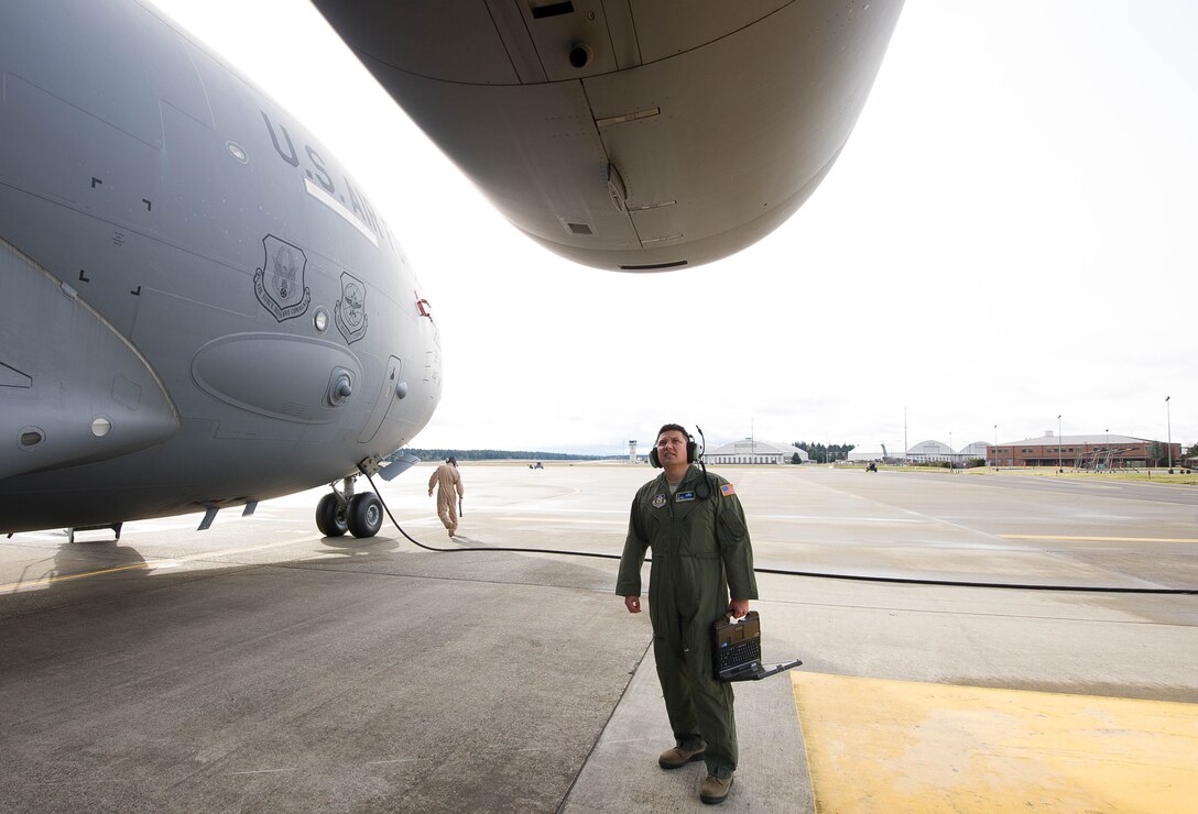 Master Sgt. Heriberto Maldonado and Tech. Sgt. Alfred Dodd perform a maintenance walk around on a C-17 Globemaster III March 3, 2017, on Joint Base Lewis-McChord, Wash. They are both flying crew chiefs, a program that started as a trial for the 446th Airlift ‘Rainier’ Wing, but is now considered essential for flying operations. (U.S. Air Force photo by David L. Yost)