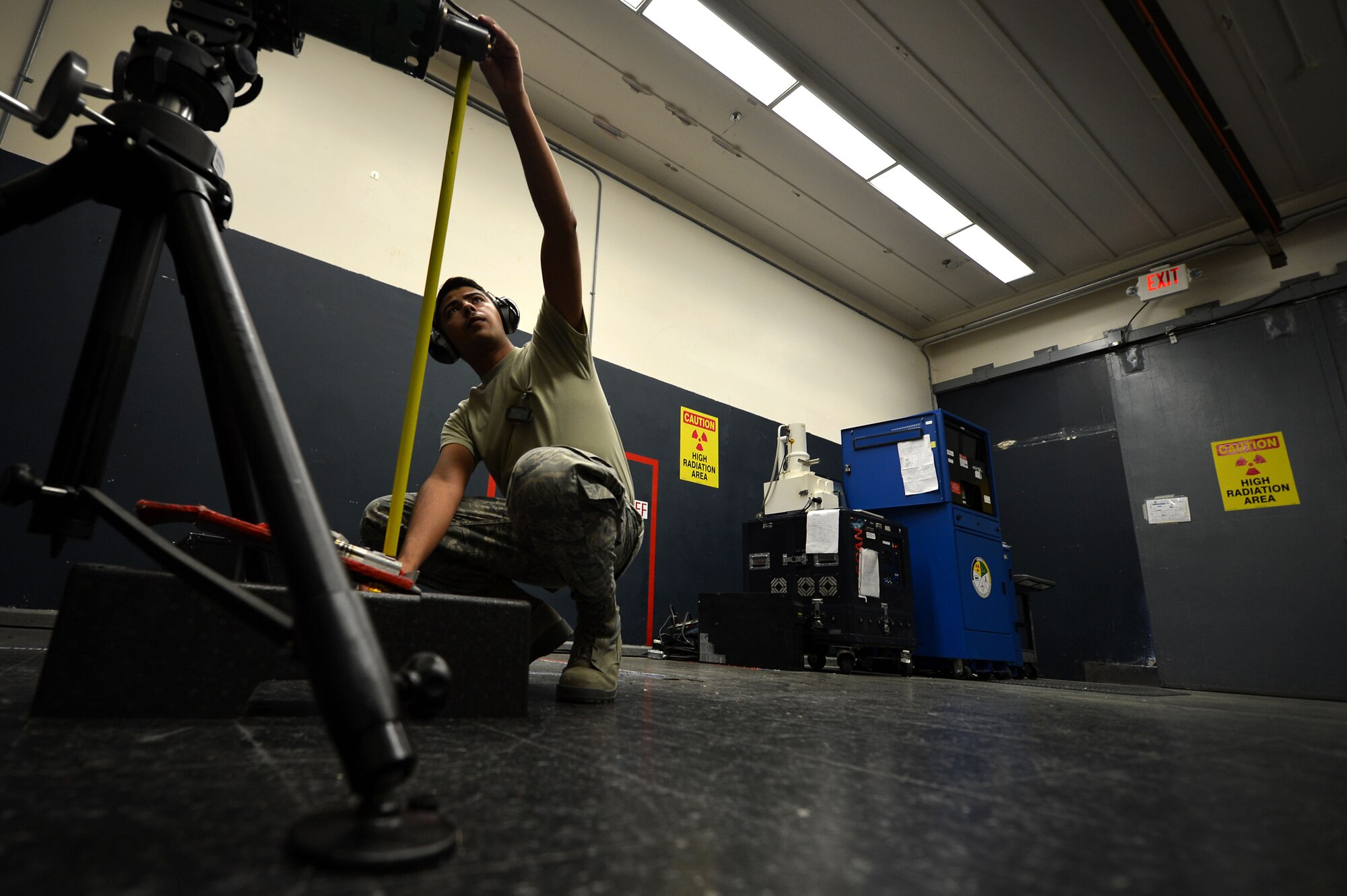 U.S. Air Force Airman 1st Class Marco Gonzalez, 20th Equipment Maintenance Squadron non-destructive inspection (NDI) apprentice, measures the distance from the discharge point to a receiving platform on an LPX160 x-ray unit machine at Shaw Air Force Base, S.C., March 7, 2017. Airmen assigned to the 20th EMS NDI flight use the machine to check for any interior damage or scratches on serviced items. (U.S. Air Force photo by Airman 1st Class Christopher Maldonado)