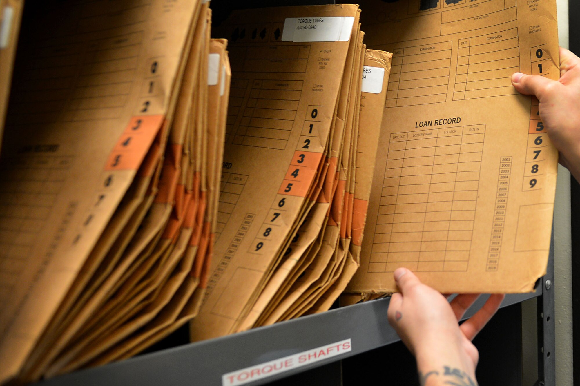 U.S. Air Force Staff Sgt. Anthony Arguello, 20th Equipment Maintenance Squadron non-destructive inspection (NDI) craftsman, stores film files after darkroom processing at Shaw Air Force Base, S.C., March 8, 2017. Airmen assigned to the 20th EMS NDI flight store x-ray files for task accountability based on equipment type. (U.S. Air Force photo by Airman 1st Class Christopher Maldonado)