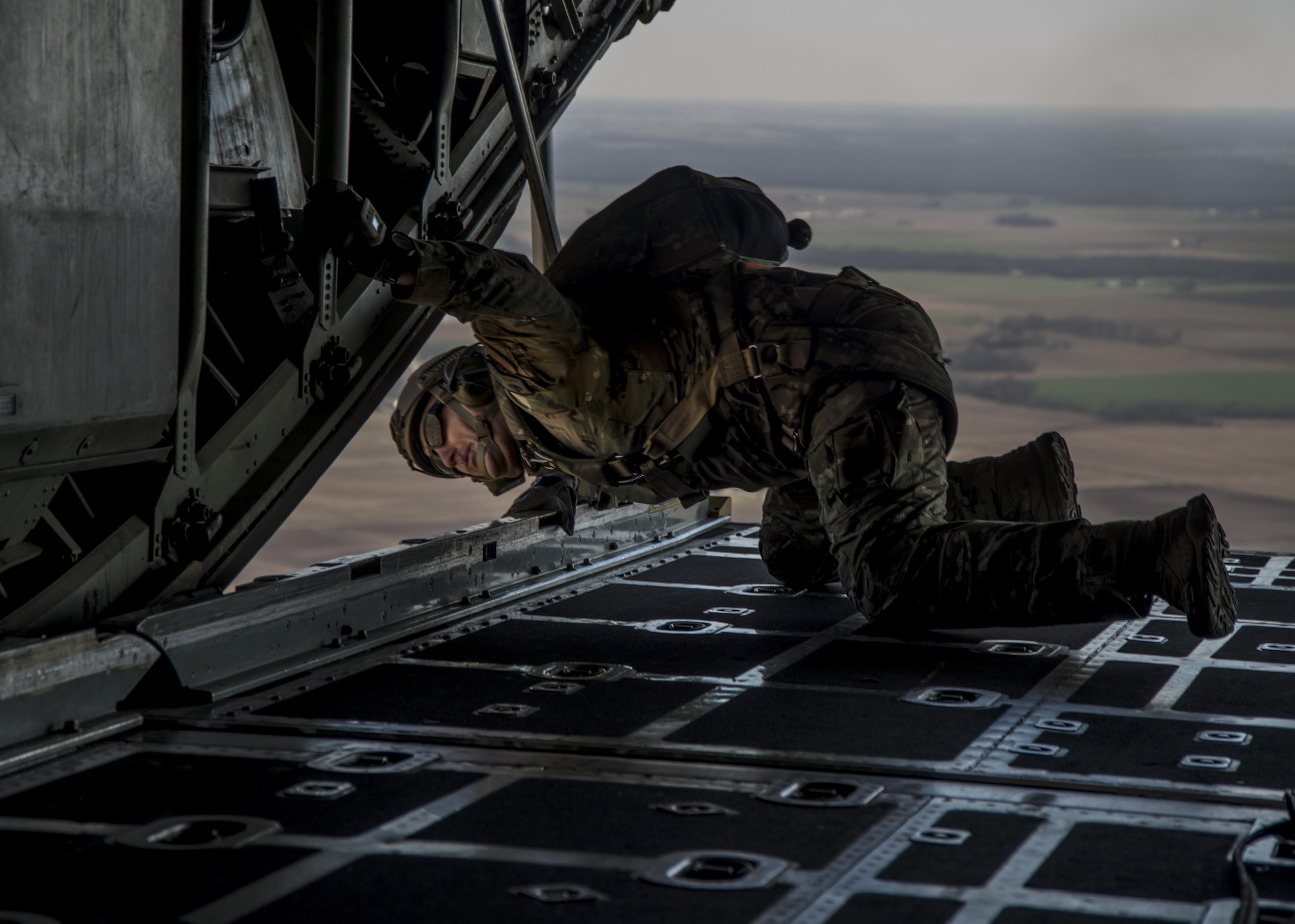 Master Sgt. Ed Dewejko, 19th Operational Support Squadron Survival, Evasion, Resistance and Escape superintendent, performs pre-jump safety checks before a static line jump from a Lockheed C-130 Hercules above the drop zone at Scott Air Force Base, Illinois March 2, 2017. The drop zone is a new addition to the airfield enhancing capabilities to conduct a diverse set of operations. (U.S.Air Force Photo by Airman 1st Class Daniel Garcia)