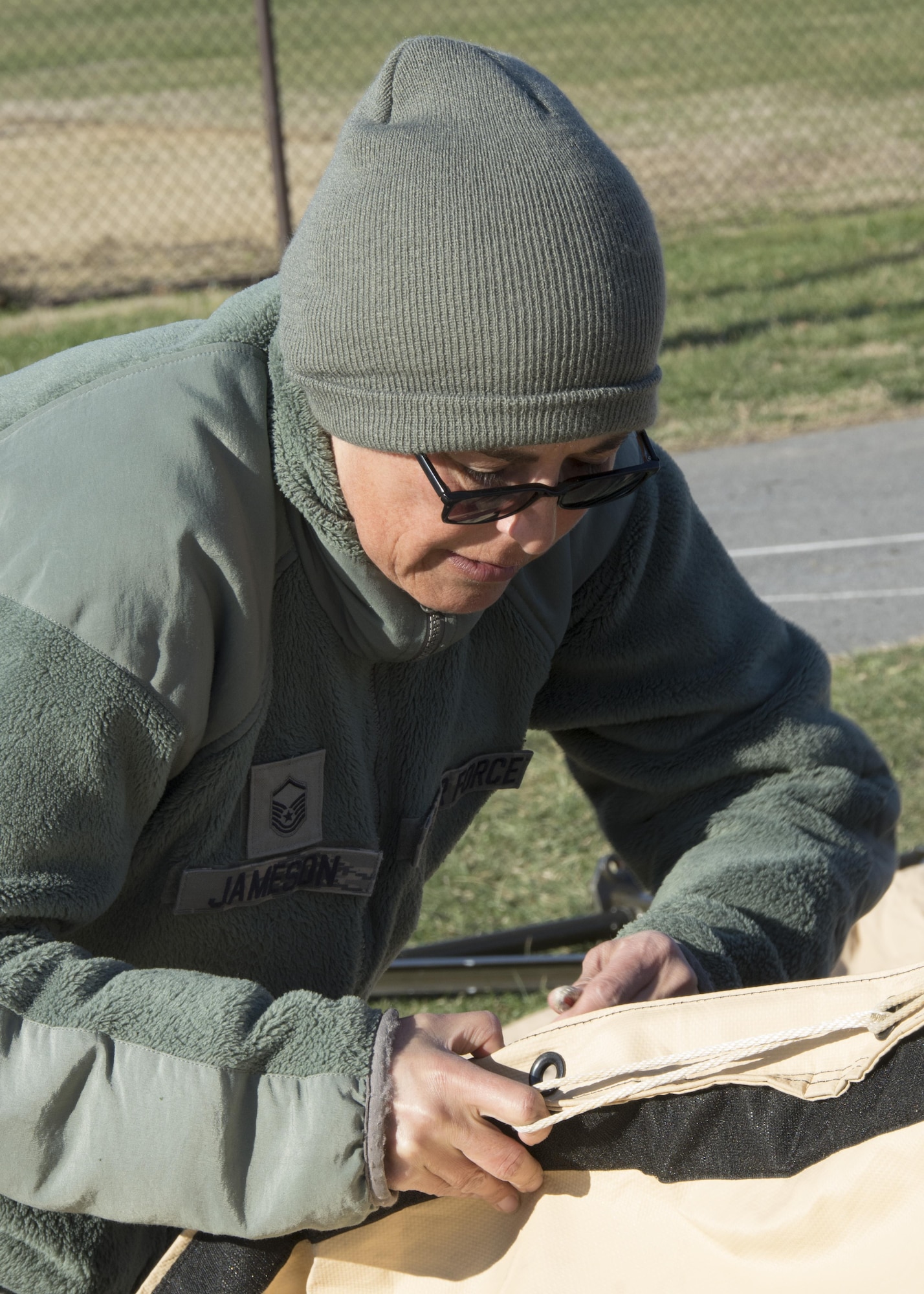 Master Sgt. Elvira Jameson, food services team leader, 512th Memorial Affairs Squadron, secures a tent while competing for the 2017 John L. Hennessy Award at Dover Air Force Base, Del., March 3, 2017. The Hennessy Award recognizes excellence in foodservices across multiple military branches. (U.S. Air Force photo / Renee M. Jackson)