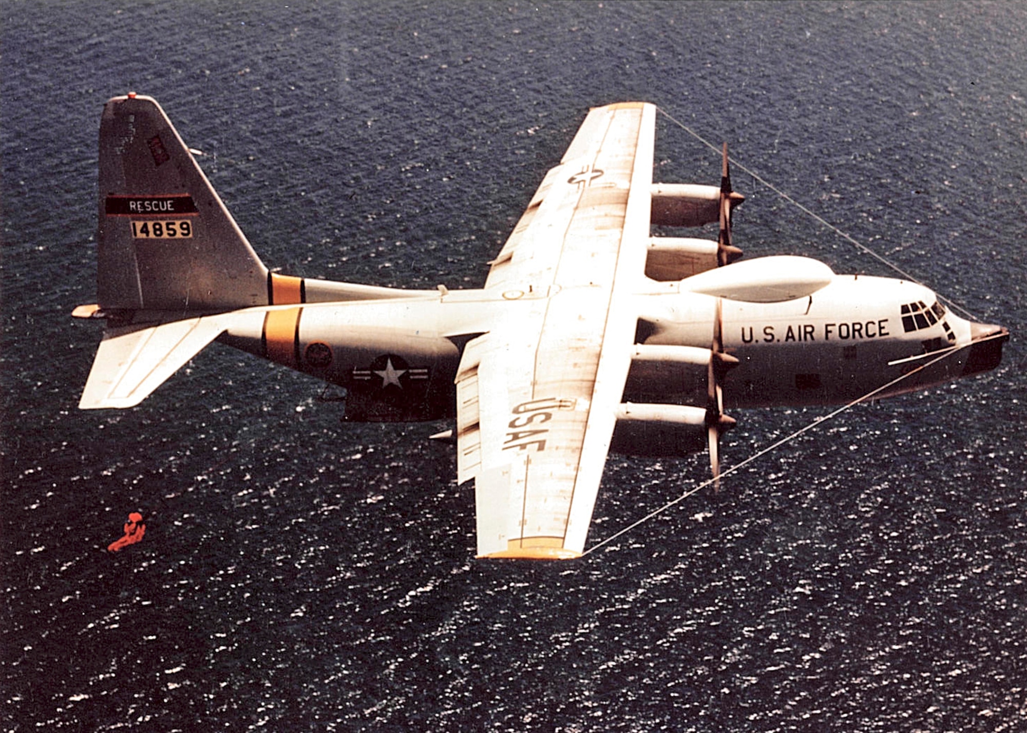 King 52 was one of a few HC-130Hs converted to conduct rescue operations in the 1960s. Pictured above is tail# 14859 conducting a Fulton Surface-To-Air Recovery System test in May 1966. The kit is dropped to a person in the water who puts on a red balloon suit with harness and is reeled aboard the plane. Recovery kits were designed for one- and two-man recoveries. (Edwards History Office photo)