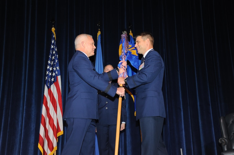 Commander of 22nd Air Force, Maj. Gen. John Stokes (left) transfers command of the 908th Airlift Wing to Col. Kenneth Ostrat during an Assumption of Command ceremony March 5 at Maxwell Air Force Base. This is Ostrat’s second time with the wing as he was previously the director of operations for the 357th Airlift Squadron from July 2008 until December 2012. (U.S. Air Force photo by Lt. Col. Jerry Lobb)