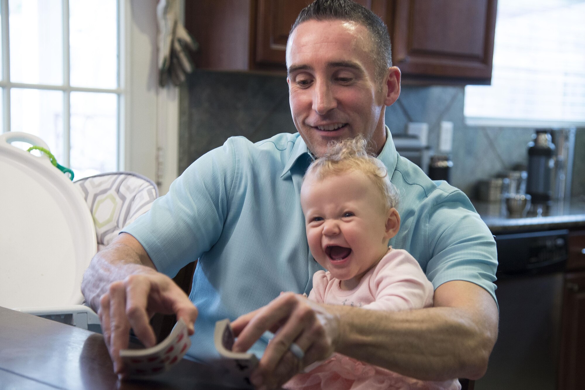 Maj.  Thomas Lessner, 39th Flying Training Squadron instructor pilot, shuffles a deck of cards during a game with his wife February 27, 2017.  (U.S. Air Force by Sean M. Worrell)