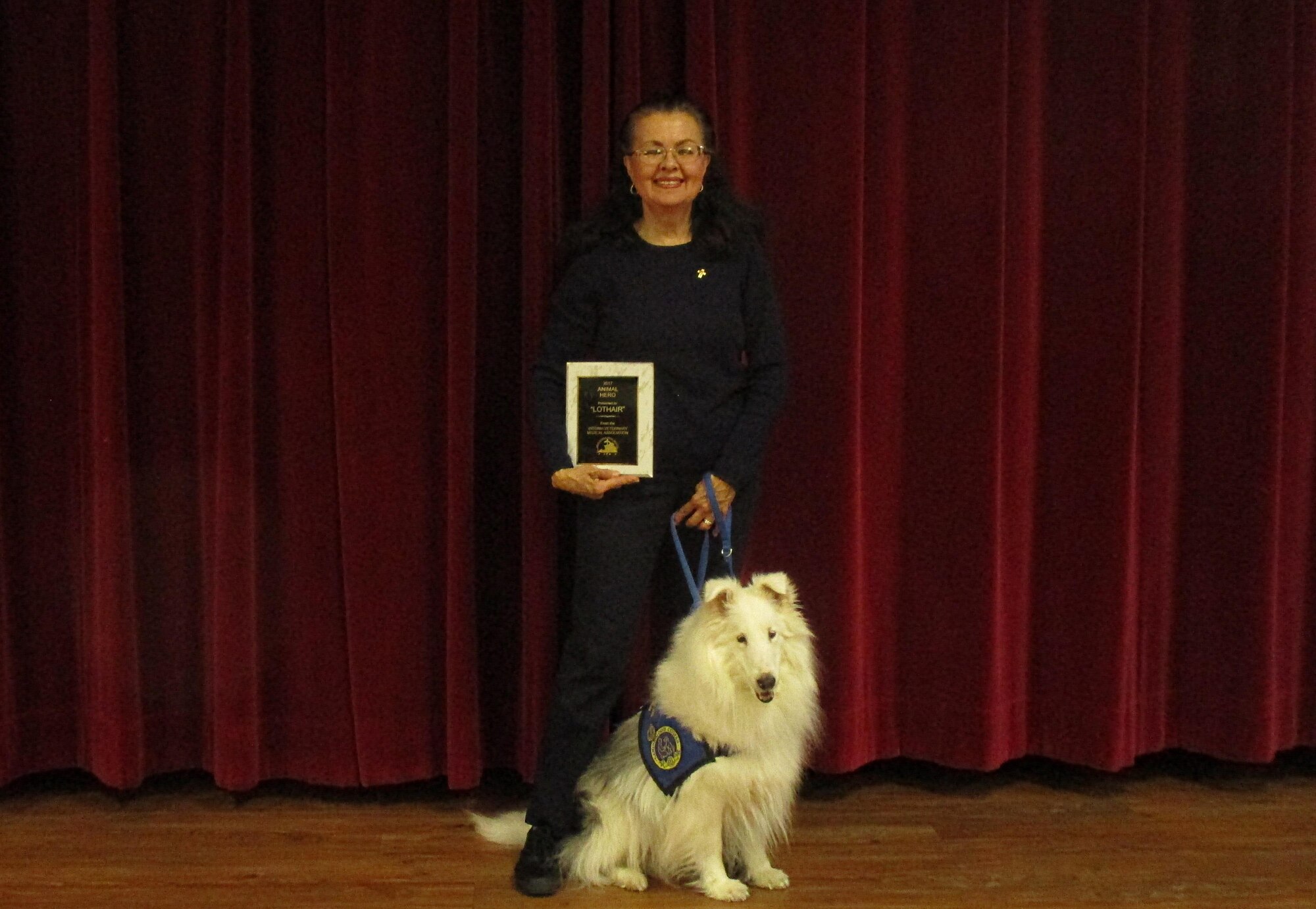 Melanie Paul and her dog Lothair, a Shetland Sheepdog, who was born deaf, accept the Animal Hero award from the Virginia Veterinary Medical Association in Hampton, Va., Feb. 18, 2017. Since Lothair was born deaf, he was trained by using American Sign Language and understands 22 different ASL signs. (courtesy photo)