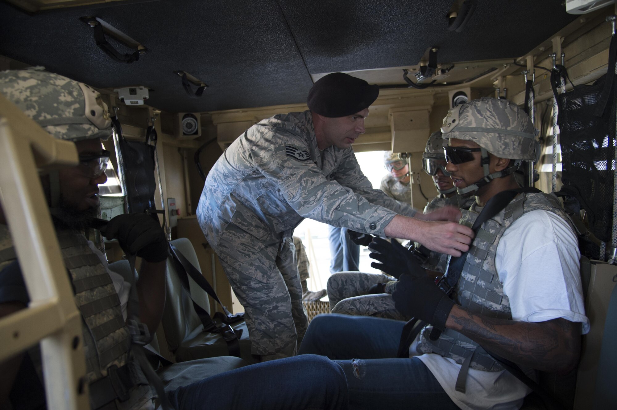 Staff Sgt. Kevin Weier, 820th Combat Operations Squadron, checks the seatbelt of Malcolm Mitchell, New England Patriots’ wide receiver and Super Bowl LI Champion, prior to a rollover demonstration in the Mine-Resistant Ambush-Protected Egress Trainer during a visit March 7, 2017, at Moody Air Force Base, Ga. Mitchell, a Valdosta native, got a glimpse of a typical day in the life of Moody Airmen. Mitchell also spent time with Airmen and signed autographs for local Patriots’ fans during his visit. (U.S. Air Force photo by Andrea Jenkins)
