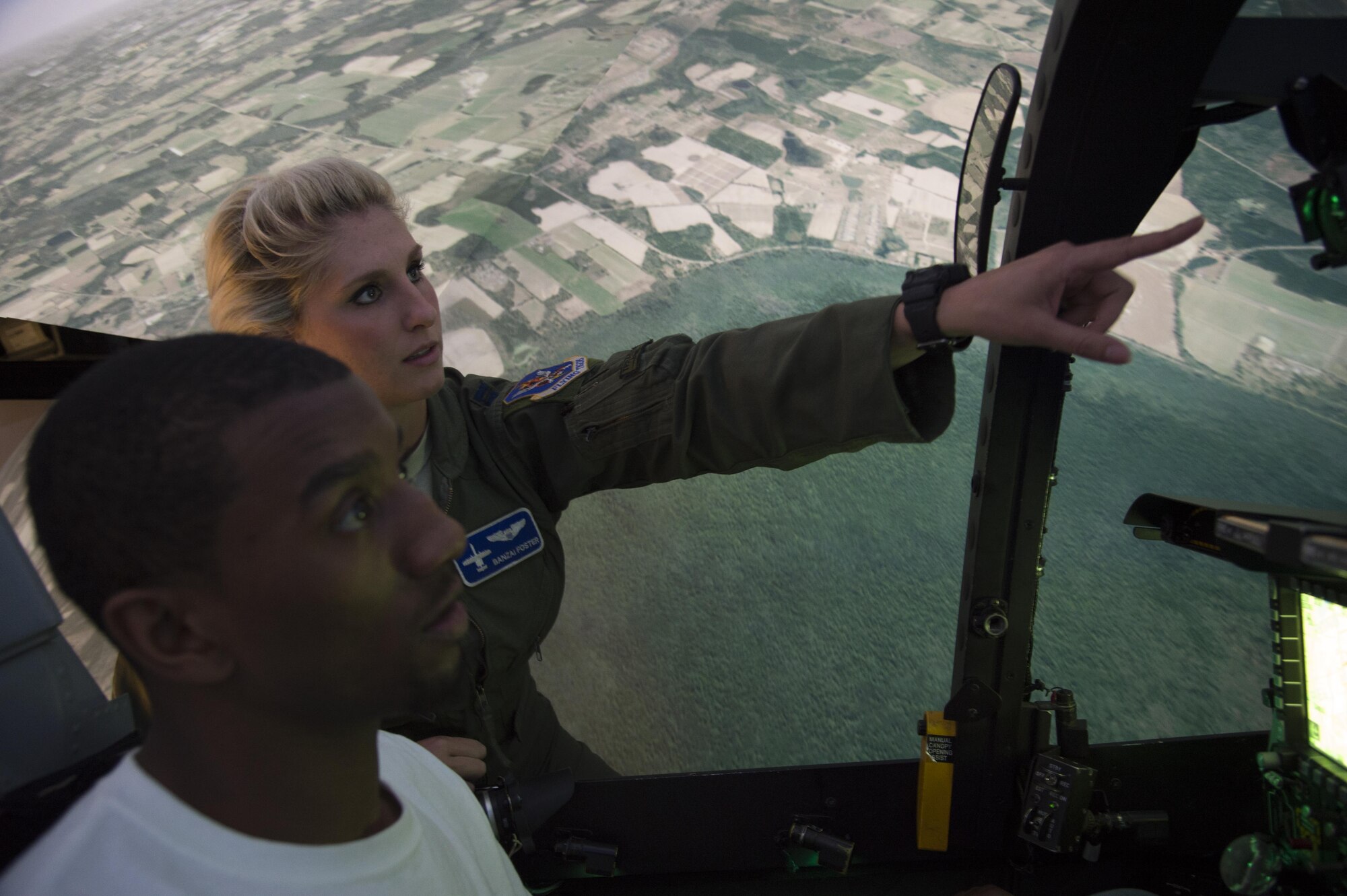 Capt. Kayla Foster, 74th Fighter Squadron A-10C Thunderbolt II pilot, gives instruction to Malcolm Mitchell, New England Patriots’ wide receiver and Super Bowl LI Champion, on operating the A-10 simulator during a visit March 7, 2017, at Moody Air Force Base, Ga. Mitchell, a Valdosta native, got a glimpse of a typical day in the life of Moody Airmen. Mitchell also spent time with Airmen and signed autographs for local Patriots’ fans during his visit. (U.S. Air Force photo by Andrea Jenkins)