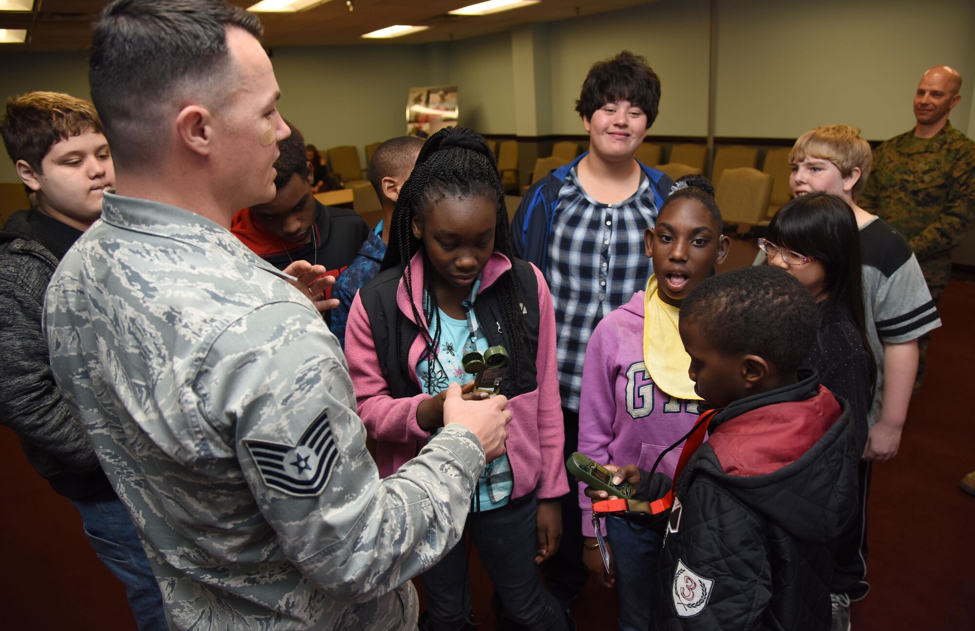 Tech. Sgt. Dominick Martin, 335th Training Squadron instructor, shows Biloxi school students how to use a weather observation kestrel at the 335th TRS weather facility during Biloxi Career Exploration Day March 2, 2017, on Keesler Air Force Base, Miss. The school-aged children also toured the 334th TRS air traffic control school, 81st Security Forces Squadron canine facility and the Keesler Fire Department. (U.S. Air Force photo by Kemberly Groue)