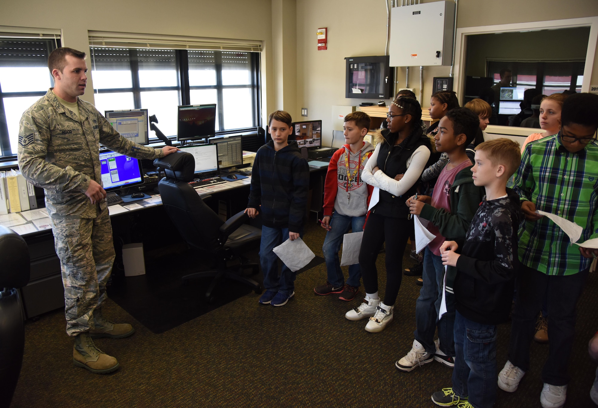 Staff Sgt. John Hood, 81st Infrastructure Division emergency communications center NCO in charge, provides a brief to school-aged children at the Keesler Fire Department during Biloxi Career Exploration Day March 2, 2017, on Keesler Air Force Base, Miss. The children also toured the 334th Training Squadron air traffic control school, 335th TRS weather facility and the 81st Security Forces Squadron canine facility. (U.S. Air Force photo by Kemberly Groue)