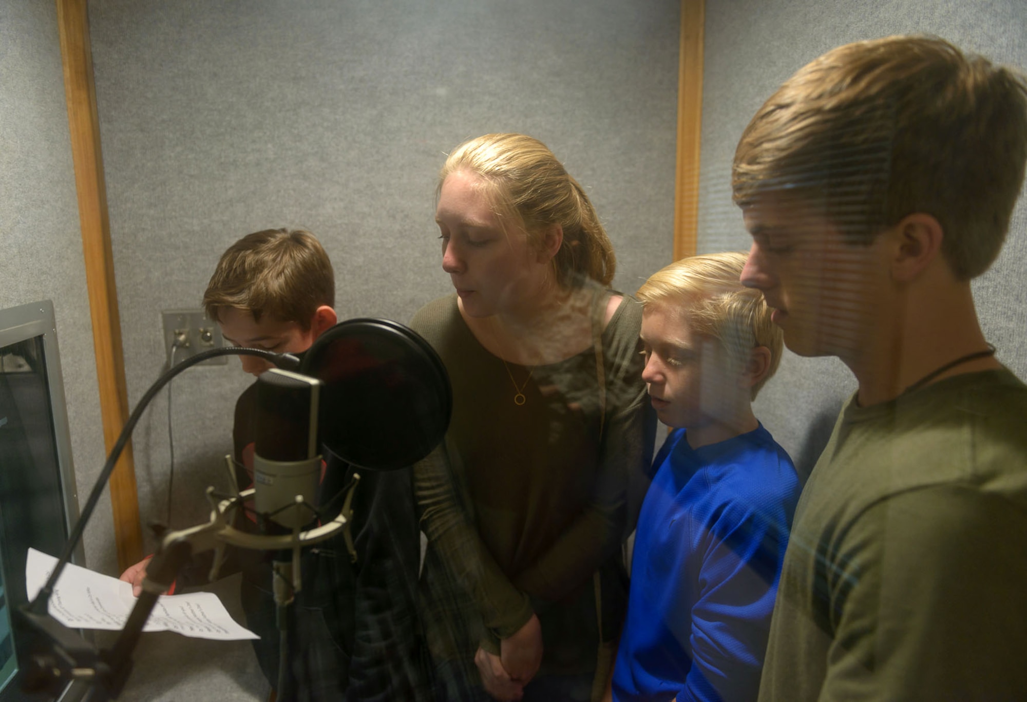 Children of 81st Training Wing leadership read a script inside the audio isolation booth at Wall Studio during Biloxi Career Exploration Day March 2, 2017, on Keesler Air Force Base, Miss. The children shadowed their parents and 81st TRW executive officers throughout the day to get a better understanding of what they do on a day-to-day basis to complete the Air Force mission. (U.S. Air Force photo by André Askew)