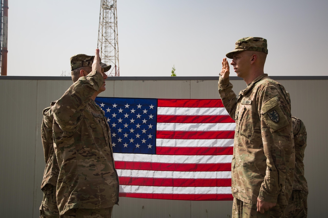 Budget certainty and investment in service members are important factors in recruiting and retaining the best all-volunteer military, the military’s top enlisted advisors told a congressional panel today. Army Spc. Justin Dingler, with the 111th Quartermaster Company Mortuary Affairs Detachment, reenlists in Erbil, Iraq, Oct. 15, 2016. Army photo by Army Sgt. Lisa Soy.