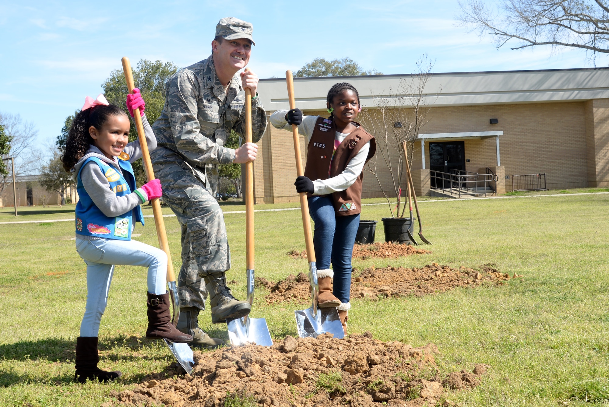 Col. Donald Lewis, 42nd Mission Support Group commander, and Montgomery Area Girl Scouts, Aria Keeler and Chloe Minnifield, commemorate Arbor Day by planting trees at the base Air Park, March 4, 2017, Maxwell Air Force Base, Ala. Lewis presided over the base’s annual Arbor Day ceremony and helped plant six new trees with help from Keeler, Minnifield and other event attendees. (U.S. Air Force photo/ Senior Airman Alexa Culbert)